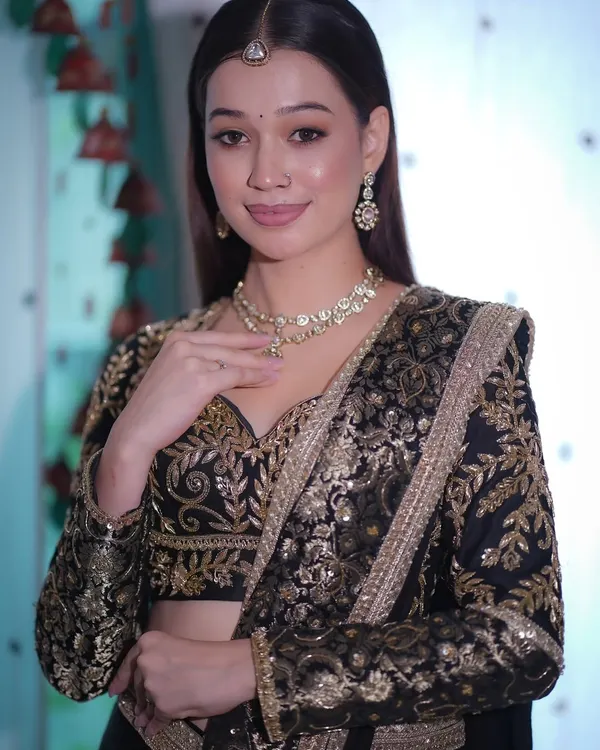 A perfect look for a Sangeet or reception. This black and gold embroidered lehenga is paired with soft, glowing skin, shimmery eyes, and a glossy nude lip for a classic, bold, and graceful statement.