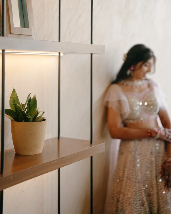 A candid portrait of the bride during her Sangeet ceremony. The soft focus and warm lighting create a dreamy and happy atmosphere.