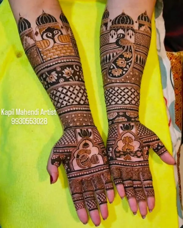 A majestic design featuring palace architecture and peacocks. The lotus motifs on the palms add a touch of grace and purity to this royal bridal mehendi.