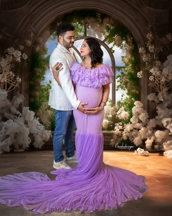 A classic couple's portrait in our fairytale studio. The flowing lavender gown and the backdrop of white flowers create a scene straight out of a dream.