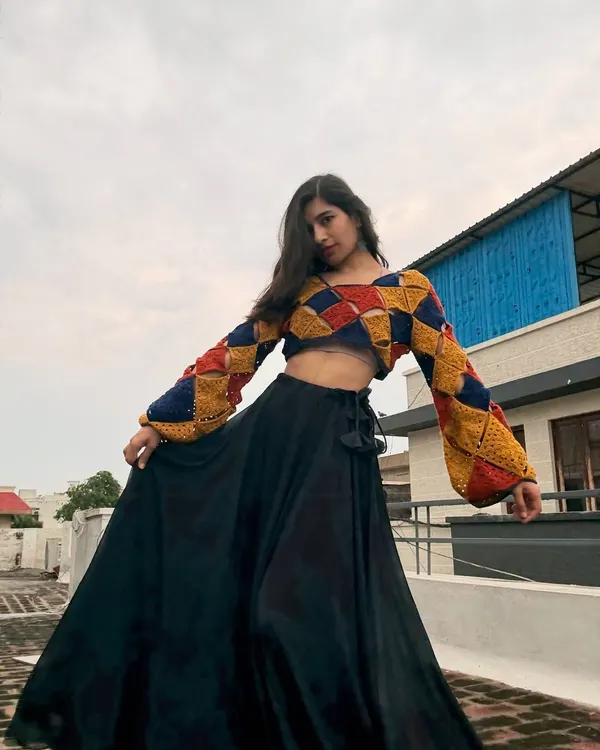 This colorful patchwork crop top is one of my favorite makes. I love playing with geometric patterns and bold colors to create something truly unique. It's made with soft cotton yarn and has fun bell sleeves, perfect for making a statement.