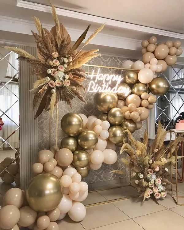 This boho-chic setup is one of my absolute favorites. I combined a custom neon sign with an organic balloon garland in neutral tones and dried pampas grass to create a sophisticated and trendy look for an adult birthday party.