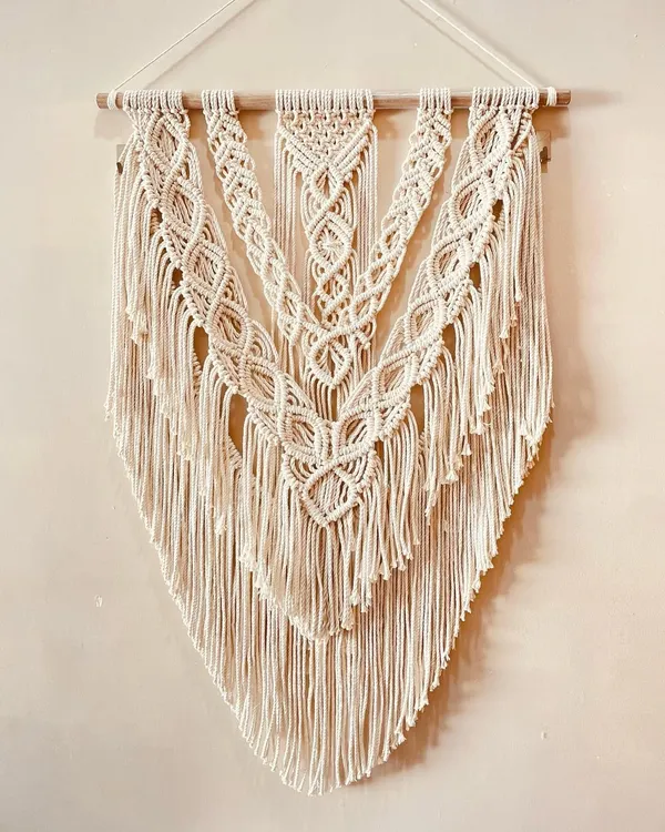 This large, V-shaped macrame hanging is a classic bohemian design. I used layers of intricate knots to create a sense of depth and texture, making it a perfect focal point for a living room or bedroom.