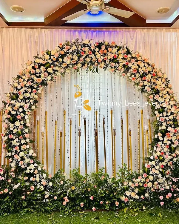 This full floral arch is one of our signature designs for engagements and receptions. We use a mix of fresh roses and baby's breath on a lush green base, creating a romantic and breathtaking backdrop for your special day.