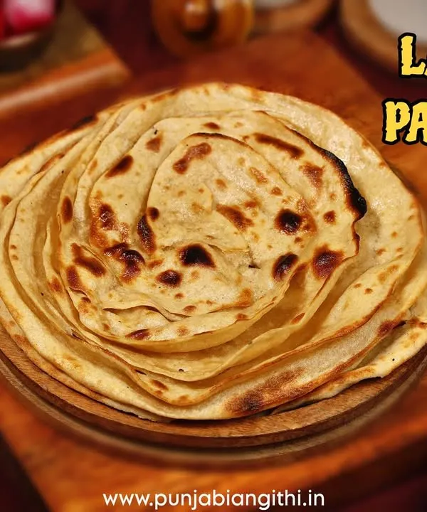 Look at the layers on my fluffy Laccha Paratha. It's crispy, flaky, and the perfect companion for any of my rich and flavorful curries.
