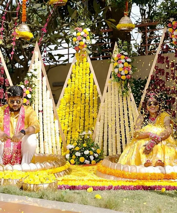 A moment of pure joy during Sukriti and Rahul's "Phoolon ki Haldi." We created this vibrant, flower-filled setting for them, and their happiness as they were showered with petals was the most beautiful sight.
