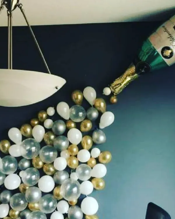 I can create fun and creative balloon art, like this champagne bottle design. It's a unique centerpiece that adds a playful and celebratory touch to any birthday or anniversary party.