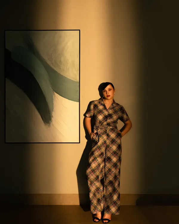 A high-fashion shot using dramatic shadows and warm light. This style is perfect for a brand campaign that wants to create a moody and artistic look.