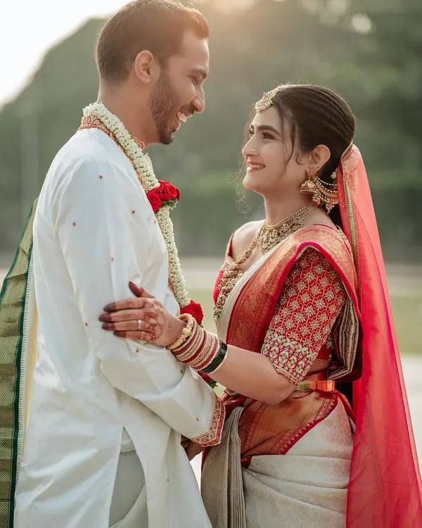 This is what it's all about. Seeing my beautiful bride, Rachana, share a moment of pure happiness. I designed her red and white Kanjivaram blouse to feel both timeless and personal.