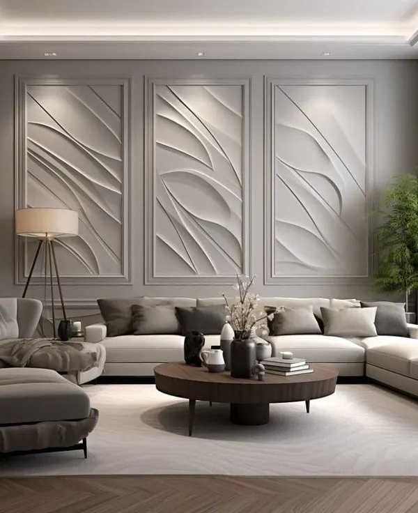 A luxurious living room featuring a stunning accent wall with three large-scale, 3D wave-patterned panels. The neutral-toned sectional sofa and minimalist decor allow the artistic wall to be the centerpiece of this sophisticated space.