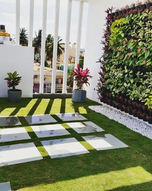 We transformed this bare Ramamurthy Nagar terrace into a modern green oasis. The design features a lush lawn, elegant marble-finish pavers, and a vibrant vertical garden wall that adds life without sacrificing space.