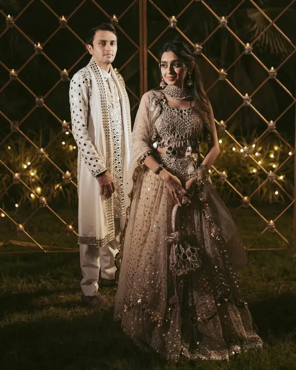 A beautiful portrait of the couple during their Garba night, showcasing their stunning, coordinated outfits against a backdrop of warm, festive lights.