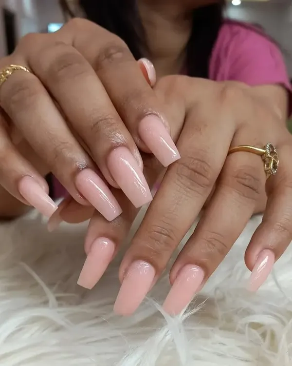 A flawless set of long, coffin-shaped extensions in a classic, glossy nude pink. This simple yet stunning look is versatile and perfect for elongating the fingers.