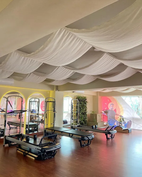 Welcome to Reform Pilates, a space I've curated for optimal fitness and mindful movement. Notice the clean lines, natural light, and state-of-the-art equipment ready for your session.
