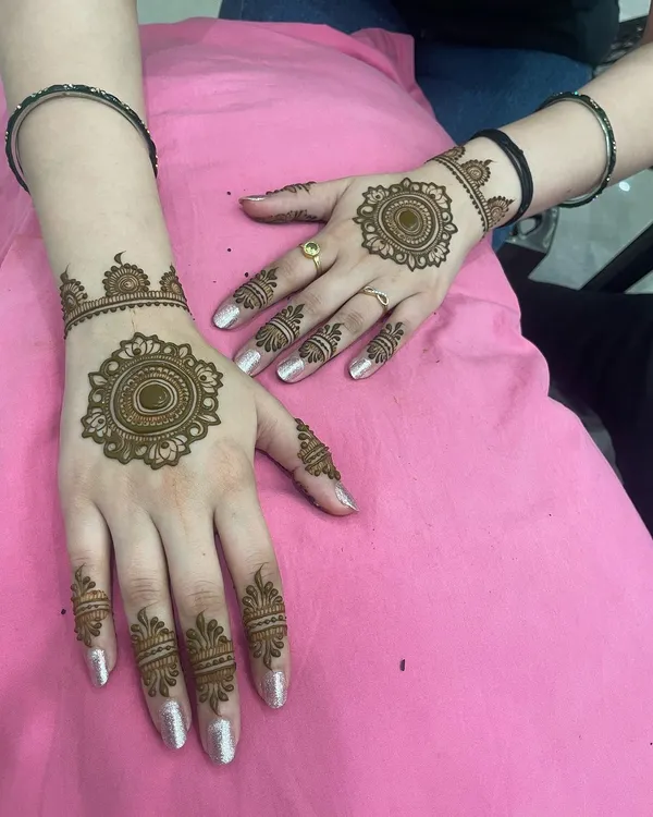 A beautiful and popular choice: matching mandala designs on the back of the hands with detailed finger work. This is a classic yet modern look.