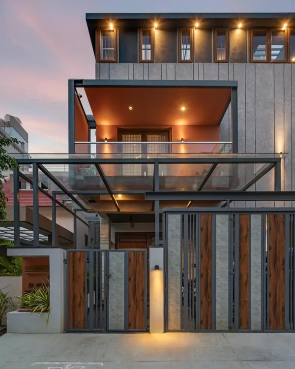 This is the 'Chirantana' residence, a compact 4-bedroom home where we used clever massing and a two-tone color palette to create a bold, modern facade. The lighting design highlights the architectural form, giving the home a distinct character in its urban neighborhood.