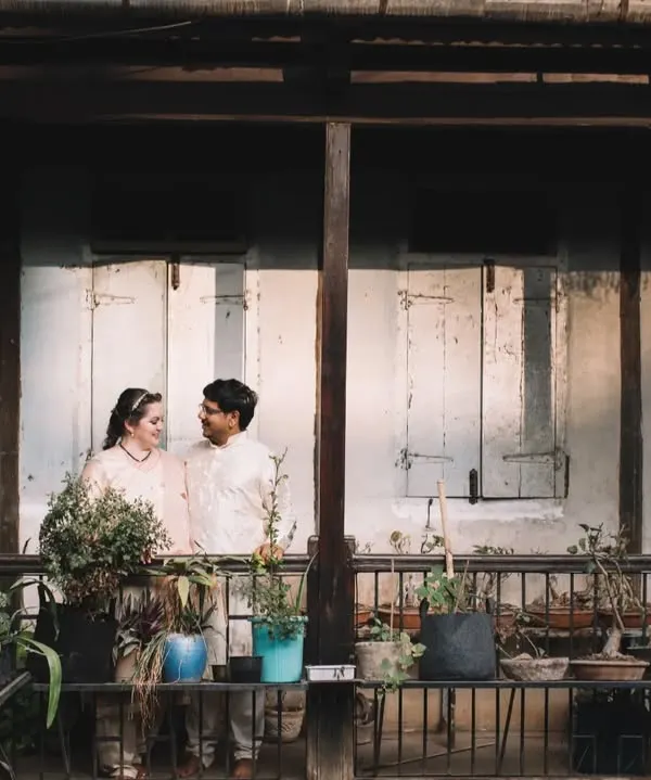 A portrait of Jessie and Purujit in the balcony of their ancestral wada. The old wooden frames and the quiet light create a beautifully rustic and timeless feel for their wedding photos.