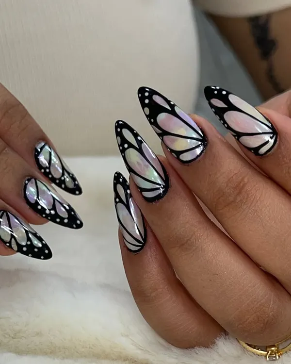 This is one of my favorite trendy designs, the iridescent butterfly wing. I create this look using chrome powders and fine line work on long almond-shaped gel extensions to give a delicate, glass-like effect.