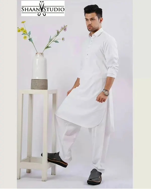 A professionally shot image of our classic white Pathani suit. This custom-tailored set is crafted for a clean, sharp look, making it an essential and timeless piece for any man's ethnic wardrobe.