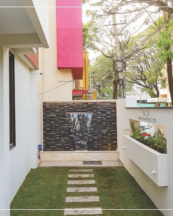 This small side yard in Hubli was transformed into a private oasis with a custom water feature, a neat lawn, and a stone pathway. It's a perfect example of our ability to create functional and beautiful landscape designs in tight urban spaces.