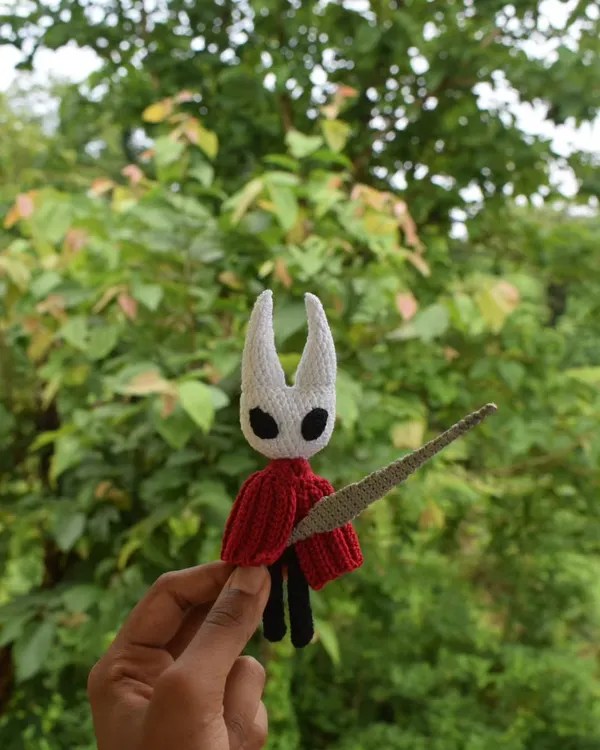 Here's a full-front view of the custom Hornet amigurumi. I paid close attention to the shape of the head and the flow of the red cloak to make it as accurate to the game as possible.