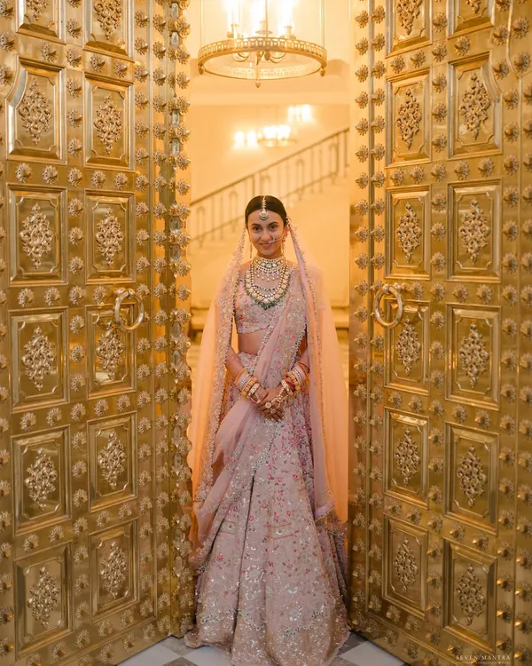 A bride's grand entrance is a moment of pure magic. I worked with Vibha to style her Anamika Khanna lehenga and the decor, ensuring her reveal through these magnificent golden doors at Mementos by ITC Hotels felt nothing short of royal.