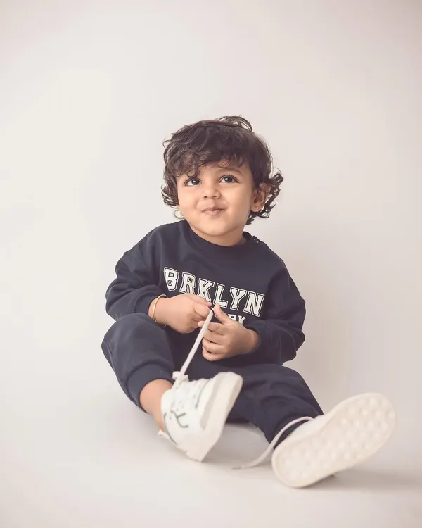 This little guy looks like a model in his casual sweatshirt. We capture kids' natural charm and style in our individual portrait sessions.