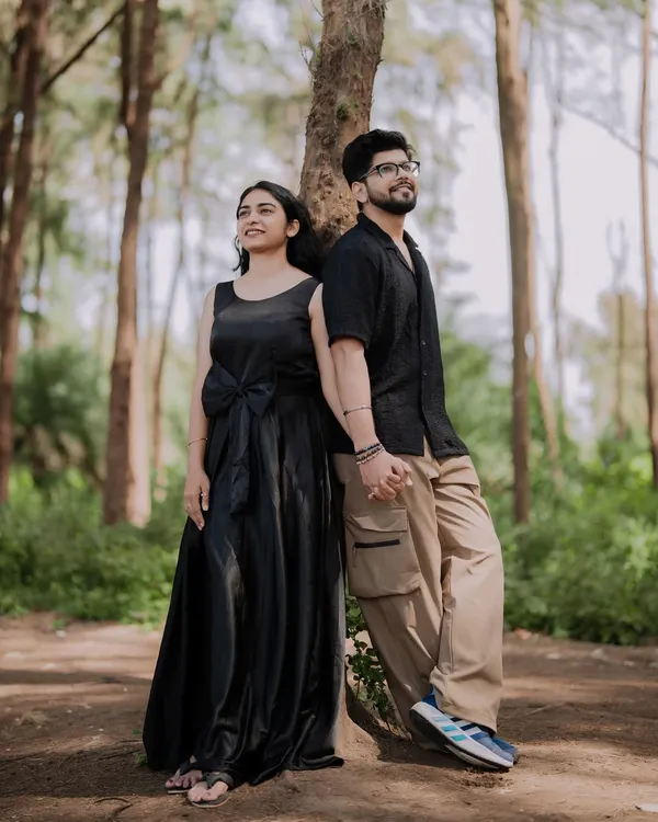 A quiet moment of reflection for the couple in a beautiful forest setting. The tall trees create a sense of intimacy and seclusion.