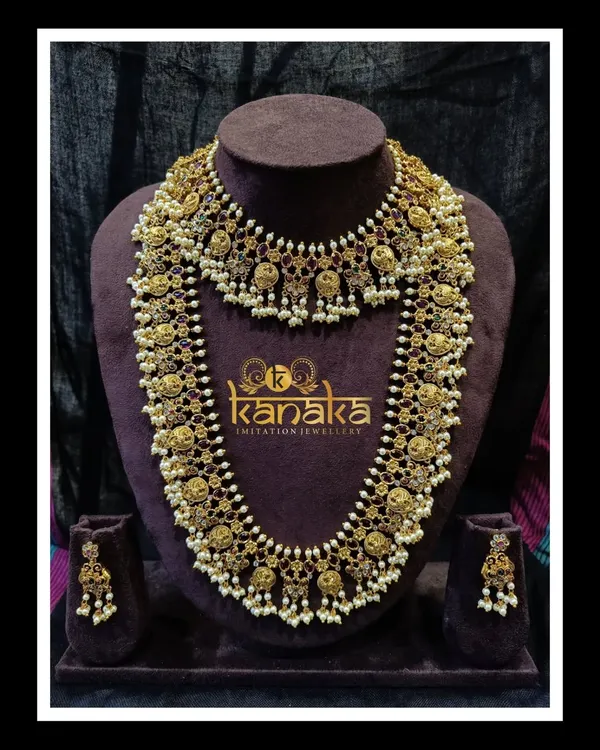 This is one of my most sought-after pieces, a traditional Guttupusalu necklace set. It features a short choker and a long haram, both with antique gold finish, coin motifs, and clusters of pearl-like beads. It’s the perfect statement piece for a bride wearing a traditional silk saree.