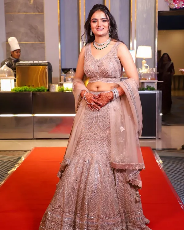 A full-length shot of my gorgeous client at her engagement. The shimmery lehenga is paired with a soft glam makeup look and loose curls for an elegant and modern feel.