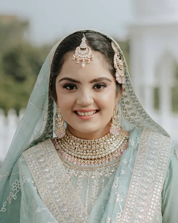 The pure joy of an Anand Karaj bride. This look is all about enhancing her natural beauty with soft makeup that radiates happiness and serenity.