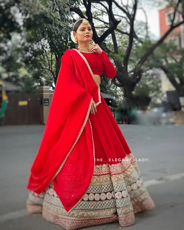 This vibrant red velvet lehenga is for the bride who wants to make a grand, unforgettable entrance. Its heavy embroidery and rich fabric are perfect for a traditional wedding ceremony, giving you that regal, cinematic feel for your big day.