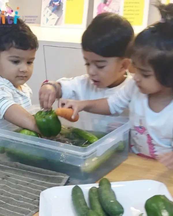 Our toddlers joyfully wash vegetables for a salad. This practical life activity introduces them to food preparation and the importance of cleanliness in a playful, sensory-rich way.