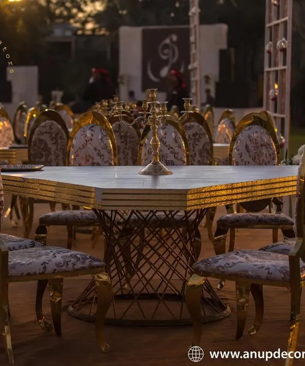 Guest comfort and style are paramount. This image showcases our luxury seating options, featuring ornate gold-framed chairs with patterned fabric and elegant square tables, perfect for a sophisticated reception dinner.