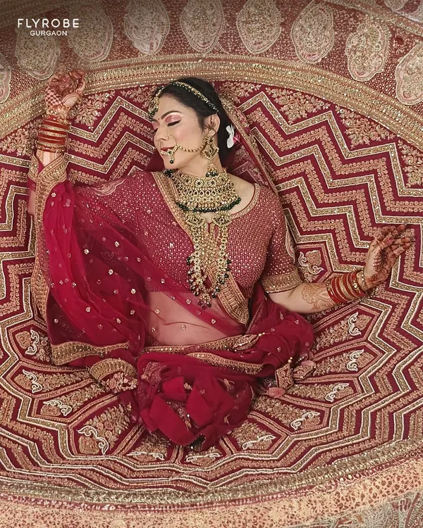Your fairytale moment is here. This stunning red bridal lehenga with intricate gold zardozi work is designed to make you the star of your big day. Why buy when you can rent this masterpiece?
