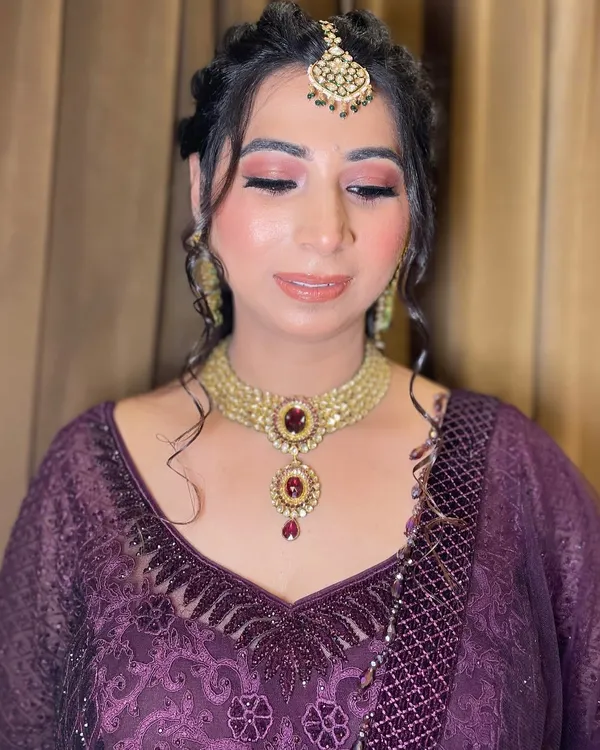 Elevating beauty with a professional touch. This look for a family function features a warm, shimmery pink eyeshadow and a glossy nude lip, creating a sophisticated and polished appearance.