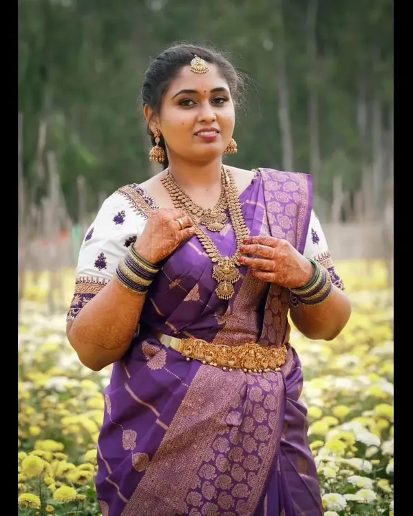 A beautiful, traditional look for an engagement. The rich purple Kanchipuram saree is paired with classic temple jewellery and makeup that enhances her features with a soft glow.