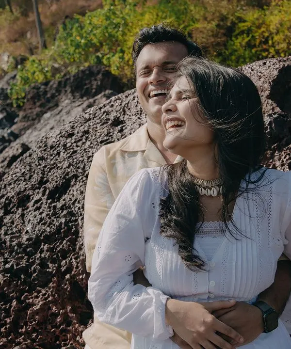 A moment of pure, uninhibited laughter on the rocky shores of Goa. We believe the best pre-wedding photos are the ones that capture your genuine joy.