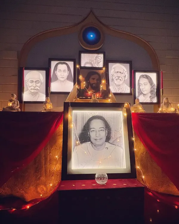 Our altar, illuminated by soft lights for an evening meditation. The portraits of the masters create a powerful focal point, helping to elevate the consciousness of all who gather here.