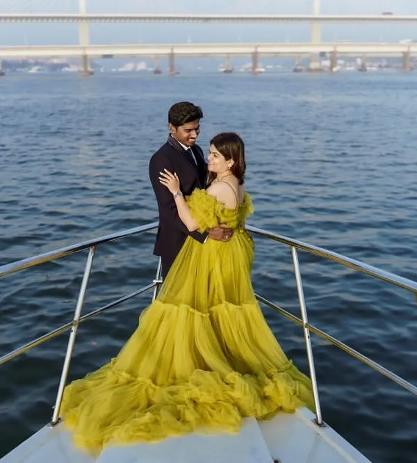 A breathtaking view of our lime green ball gown on a yacht, with the city bridge in the background. This is the ultimate luxury maternity shoot experience.
