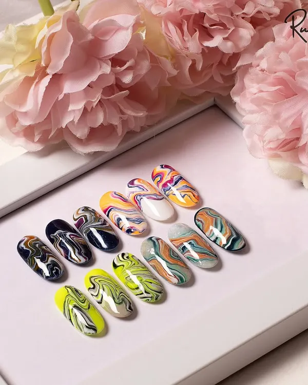 A collection of my hand-painted marble nail designs. Each one is unique, with fluid patterns and beautiful color combinations.