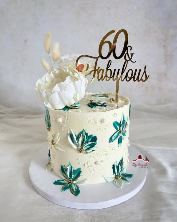 A striking beauty for a 60th birthday. I used a palette knife to create these beautiful teal and white buttercream flowers, accented with gold for a touch of elegance.
