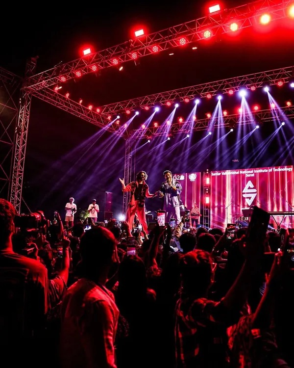 A wide shot of Sachin-Jigar commanding the stage at NIT Surat's Sparsh festival. This is the scale of production and crowd energy we deliver for every headlining performance.