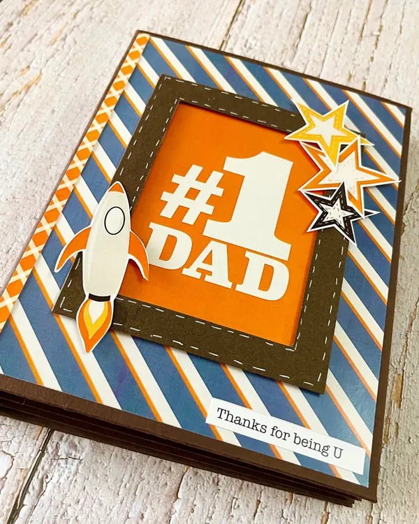 Our "#1 Dad" themed album is the perfect way to celebrate your father. The cover features a bold design with a rocket ship, symbolizing how he has always helped you reach for the stars.