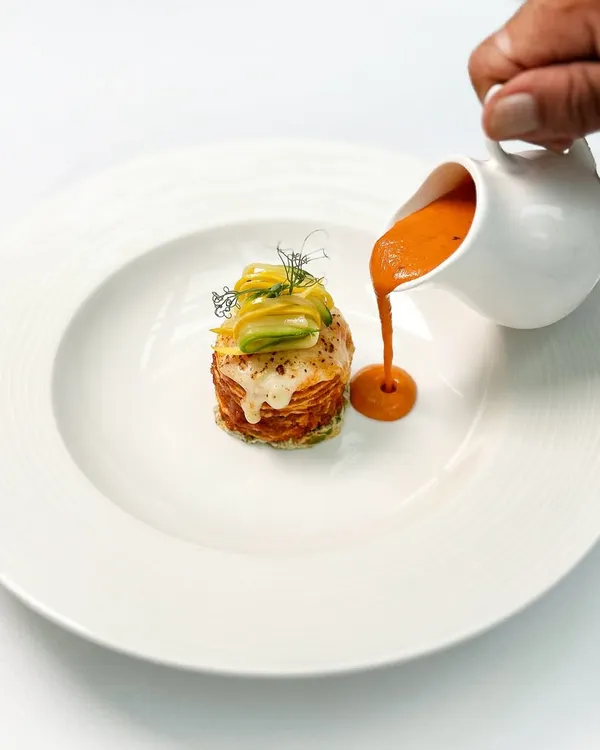 Our paneer lasagna is a study in comfort and creativity. Layers of soft paneer are stacked with smoked aubergine and finished with a rich goji berry makhani sauce poured tableside.