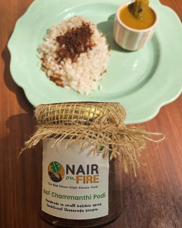 This is my magical Chammanthi Podi, showcased with its most classic pairing: a simple mound of rice. The jar itself holds a dense, smoky, and tangy chutney powder that is a must-have for adding a taste of home to any meal, anywhere you go.