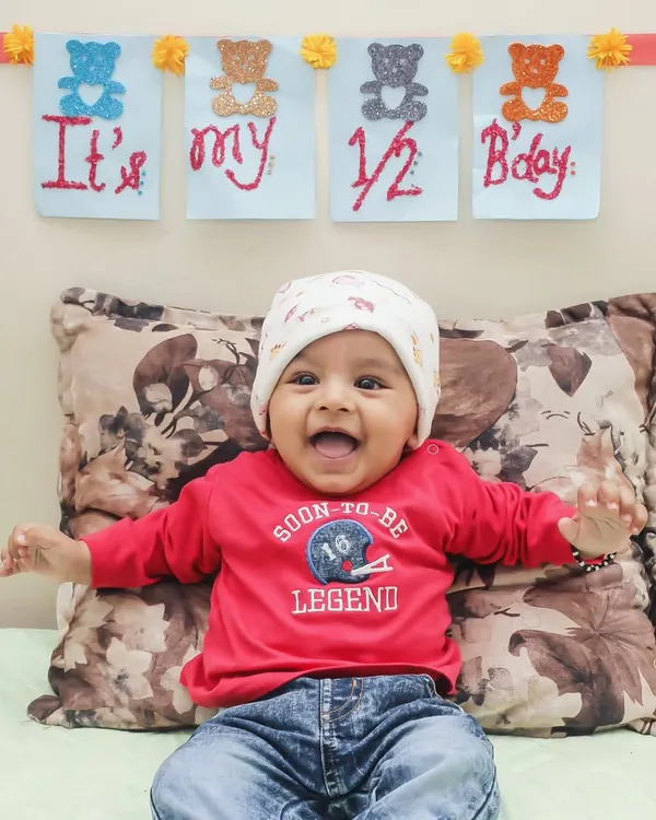 Celebrating a half-birthday is a wonderful milestone. This little legend's smile shows just how much fun we have during these special baby photoshoots.