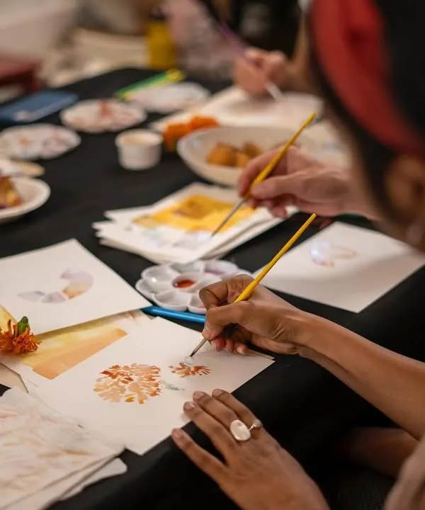 This is the heart of our botanical ink workshop. A participant carefully paints with colors they helped create, extracted directly from flowers and natural materials. It’s a magical process of turning nature into art, one brushstroke at a time.
