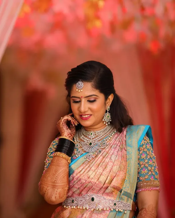 Rashmi looking absolutely breathtaking for her reception. The makeup features soft, shimmering eyes and is paired with stunning diamond jewelry for a truly glamorous look.