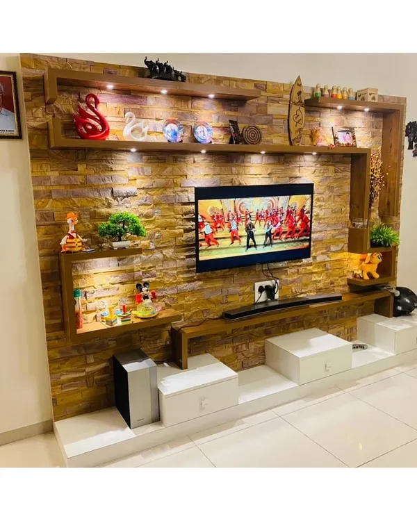This is our approach to creating a stunning focal point in your living room. We used a floor-to-ceiling stone-cladding effect, integrated with custom shelving and warm ambient lighting, to build a TV unit that is both a media center and a piece of art.